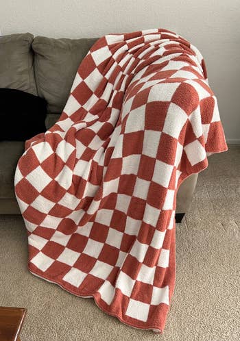 Checkered pattern blanket draped over a sofa, showcasing home decor style