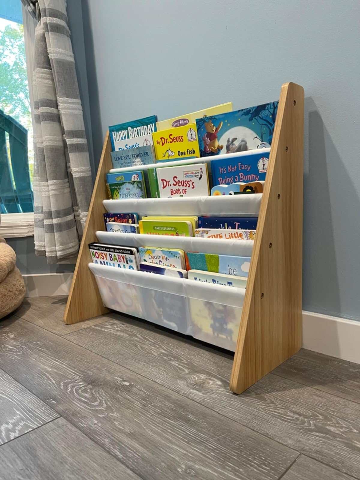 a reviewer photograph  of the publication  rack loaded with children's books successful  achromatic  
