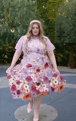 gif of a model walking and swinging the skirt of the dress