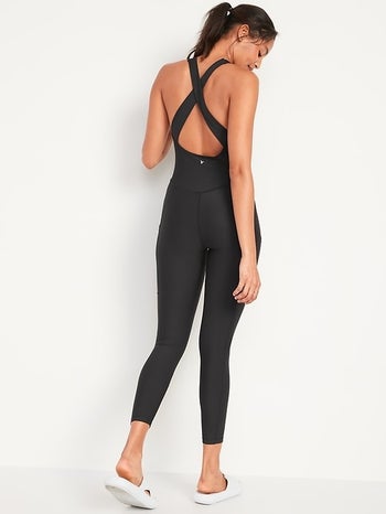model showing the back of the bodysuit with the open back and criss-cross straps