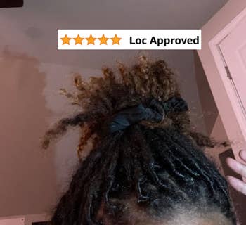 Close up of reviewer with locs wearing the black scrunchie, 