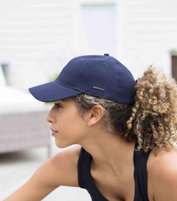 a model wearing a navy baseball cap