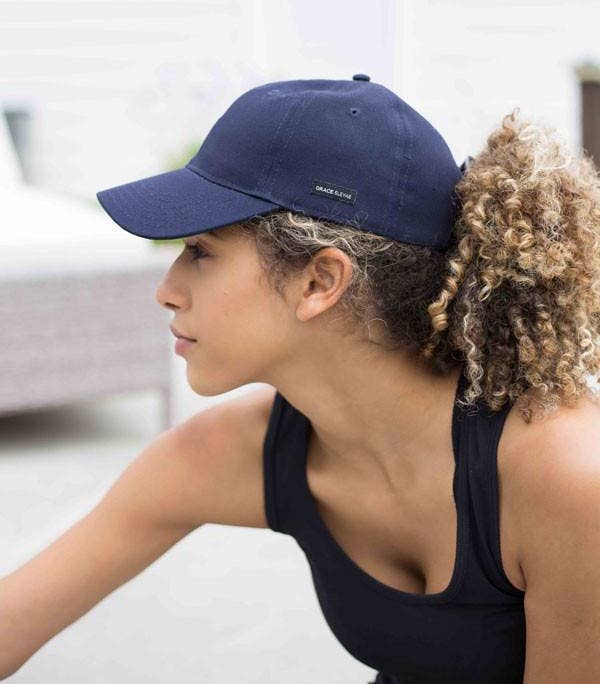 a model wearing a navy baseball cap