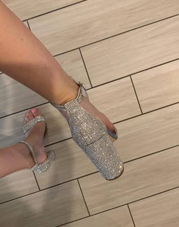 back of reviewer's foot in the sparkly heel