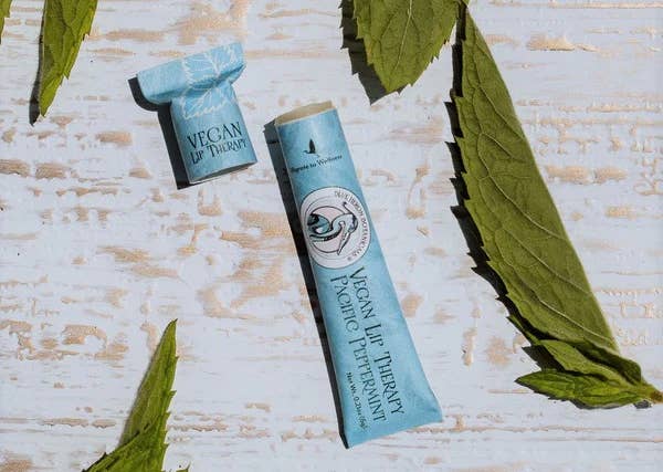 a blue paper tube of vegan lip therapy 