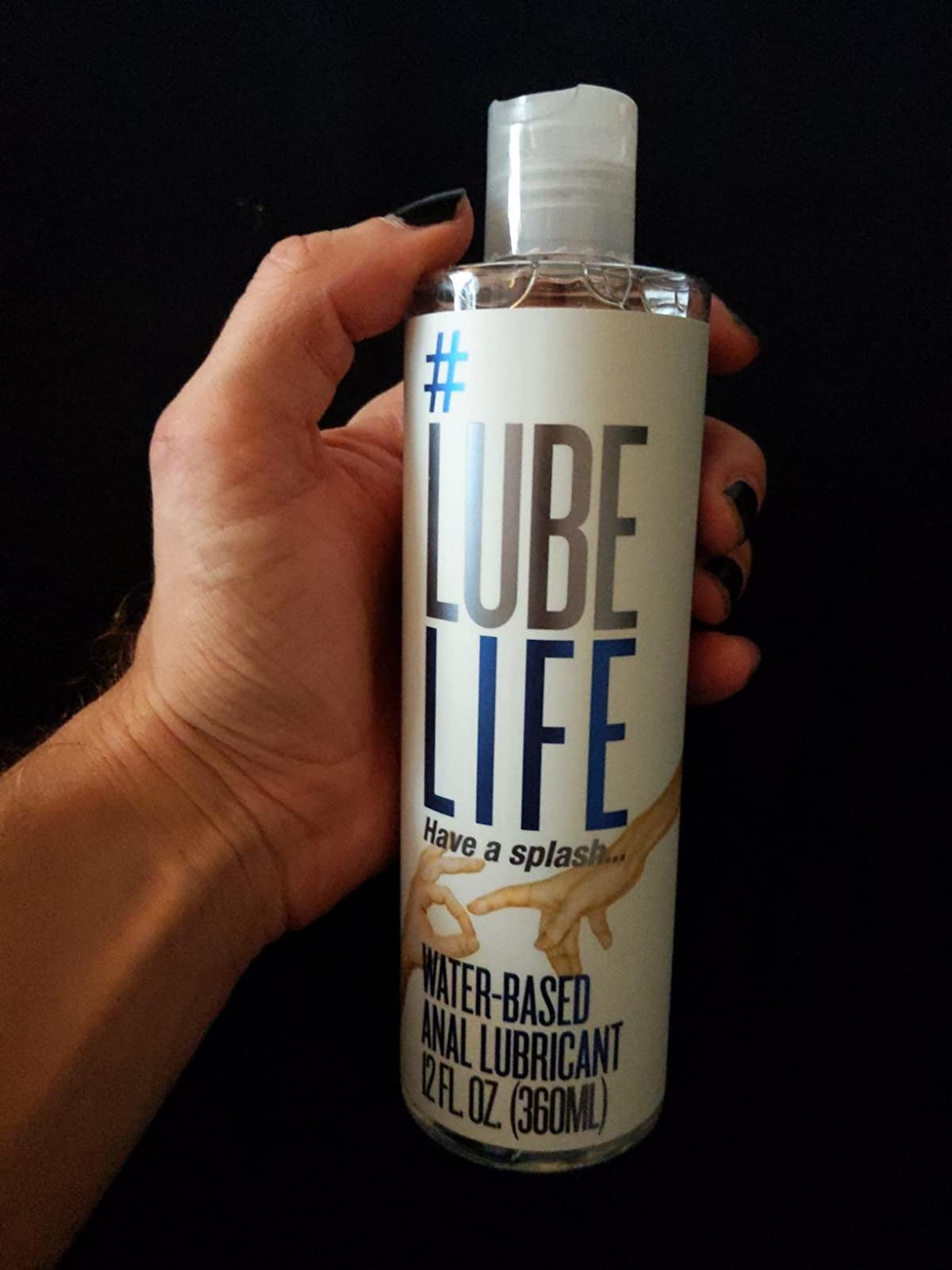 Model holding white and blue bottle of lubricant
