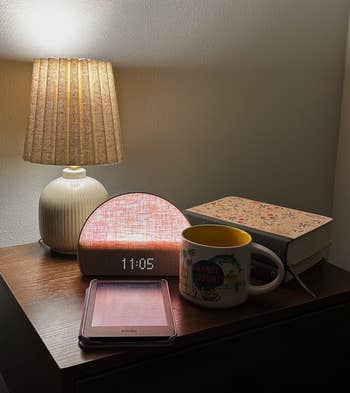 05, a Kindle, a mug, and a closed publication  with a floral cover