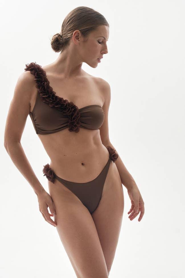 A model posing in the brown set showing the mesh floral sides on the top and bottom