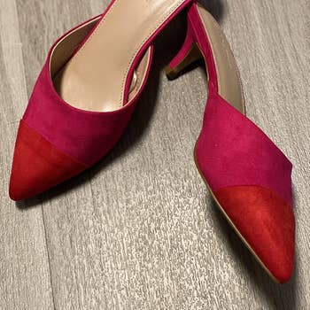 a reviewer photo of the mules in red and pink 