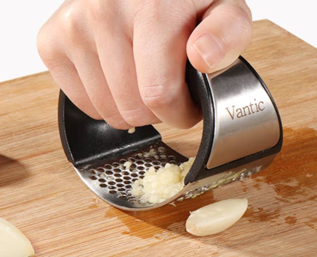 model hand rolling the garlic 
