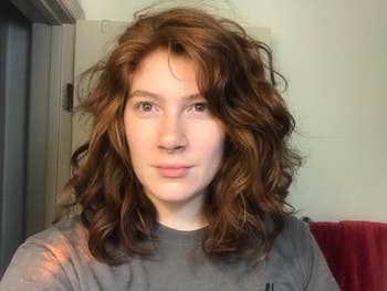 reviewer photo of them showing off their wavy/curly brown hair