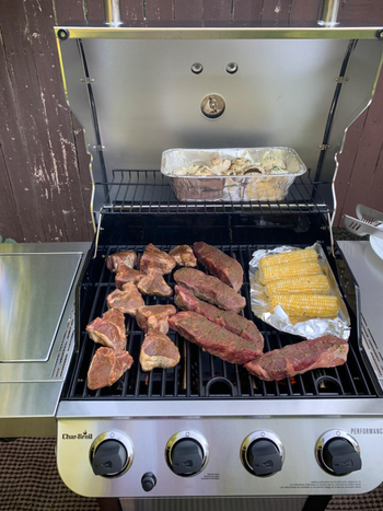 reviewer photo of meat and corn being cooked on the grill