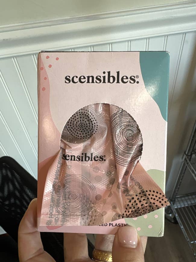 A manus  holds a container  of 