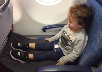 A child's feet up on the airplane bed