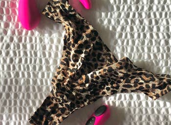 Pink panty vibrator next to leopard underwear