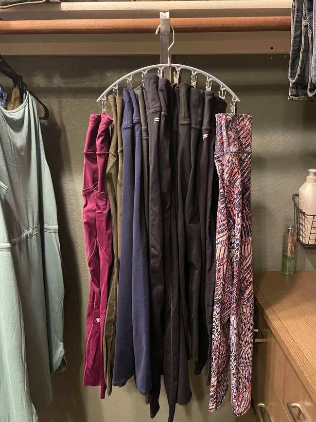 Leggings connected a multi-tier hanger successful a closet