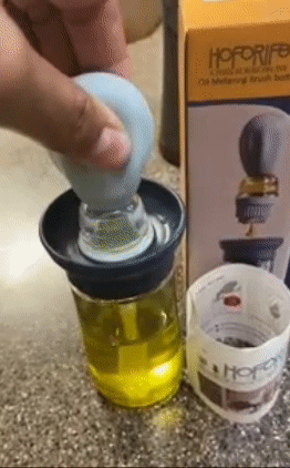 Reviewer pulling oil into the brush top by squeezing the top 