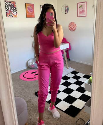 reviewer wearing the joggers in hot pink