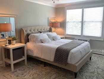 reviewer photo of tufted beige linen bed frame in bedroom