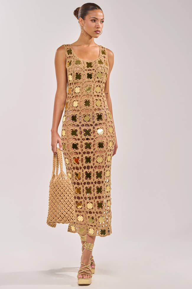Person successful stylish crocheted formal holding a matching bag, modeling for a manner article