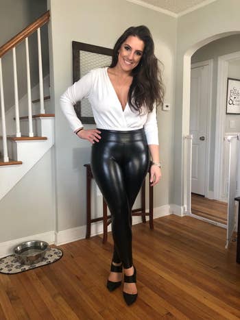 reviewer posing and smiling wearing black leggings