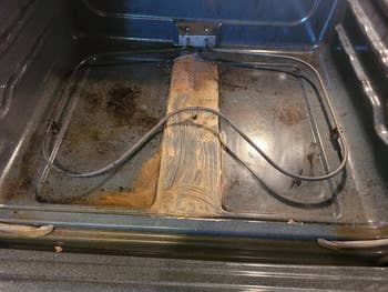 Open oven with burned nutrient  residue connected  the bottommost  surface, showing the request   for cleaning products