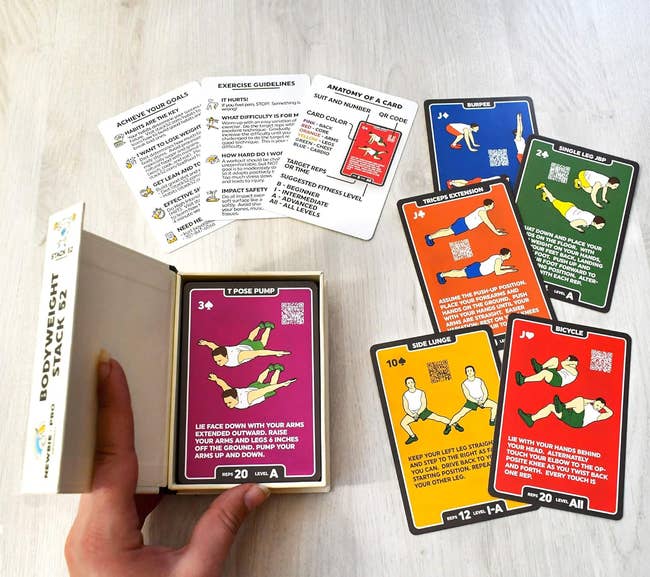 an open box with the card deck inside and cards of different colors featuring different exercises on each 