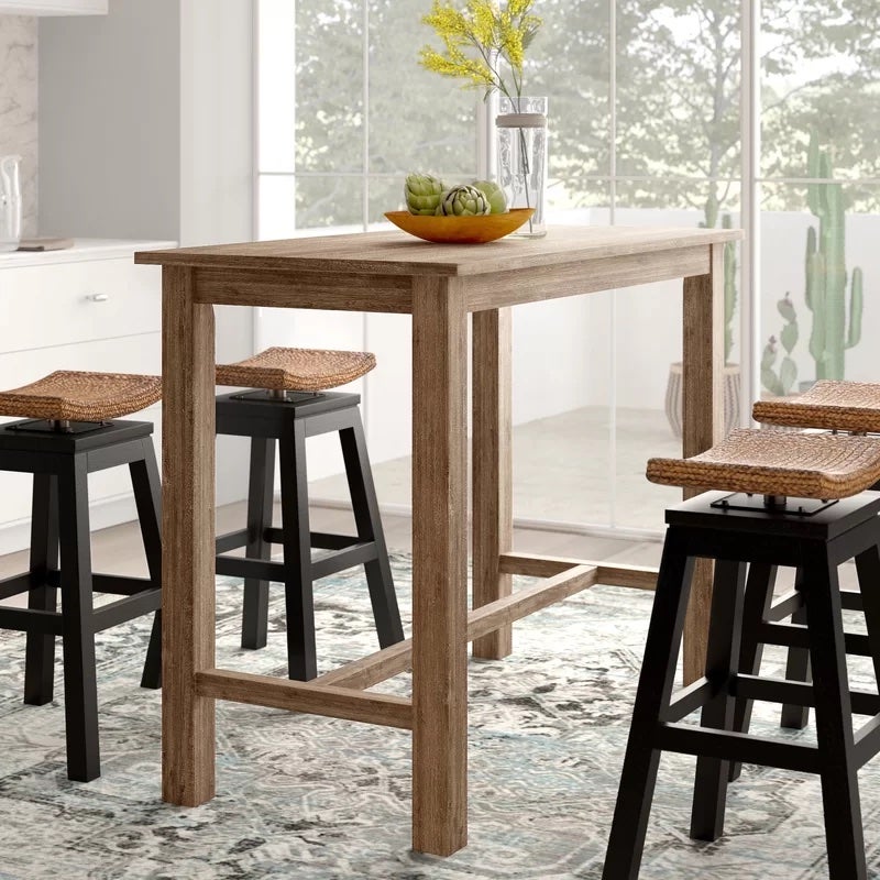 A tall brown table with four chairs