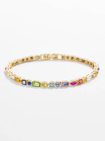 Thin gold bracelet with different sized rainbow stones 