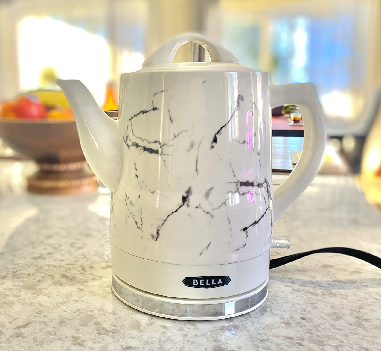 reviewer photo of the white and black marbled tea kettle on a kitchen counter