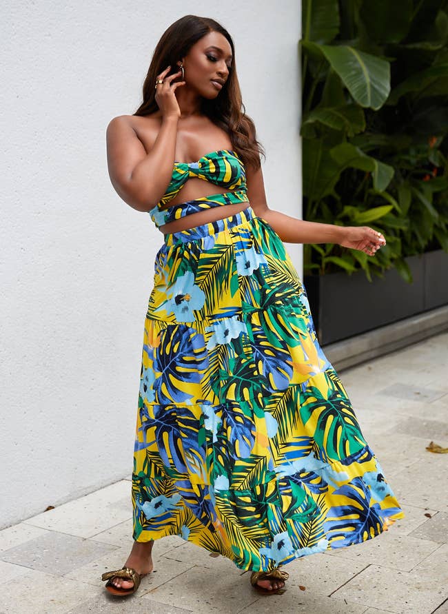 the yellow, green, and blue tropical print sent being worn with sandals