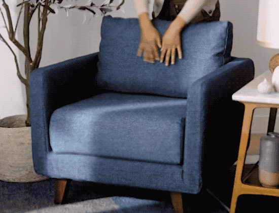 gif of a model removing the chair's blue slip cover and tossing it in the wash