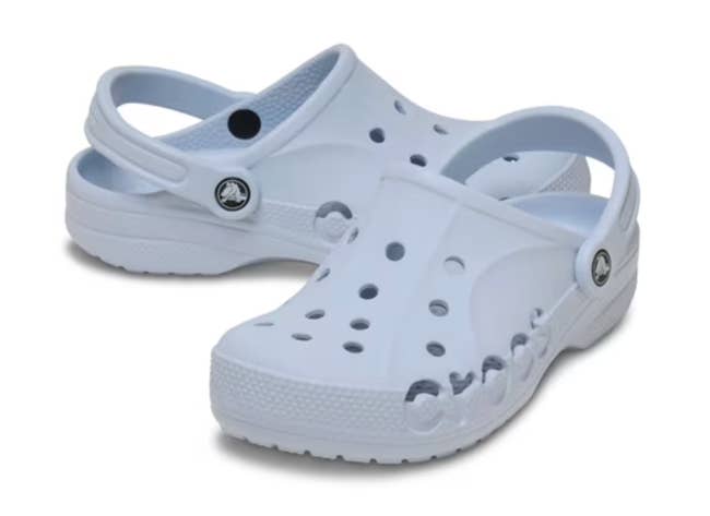 White Crocs with perforated plan and a textured sole, featuring an adjustable bottommost strap. Ideal for casual and comfy footwear
