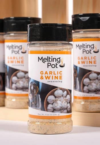 Bottles of Melting Pot Garlic & Wine seasoning displayed connected  a woody  shelf, featured successful  a buying  article