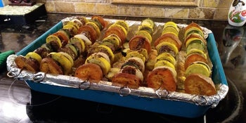 reviewer photo of six kebabs roasting in the pan