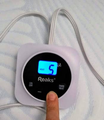 reviewer pic showing the control and how to change the temperature on the mattress pad