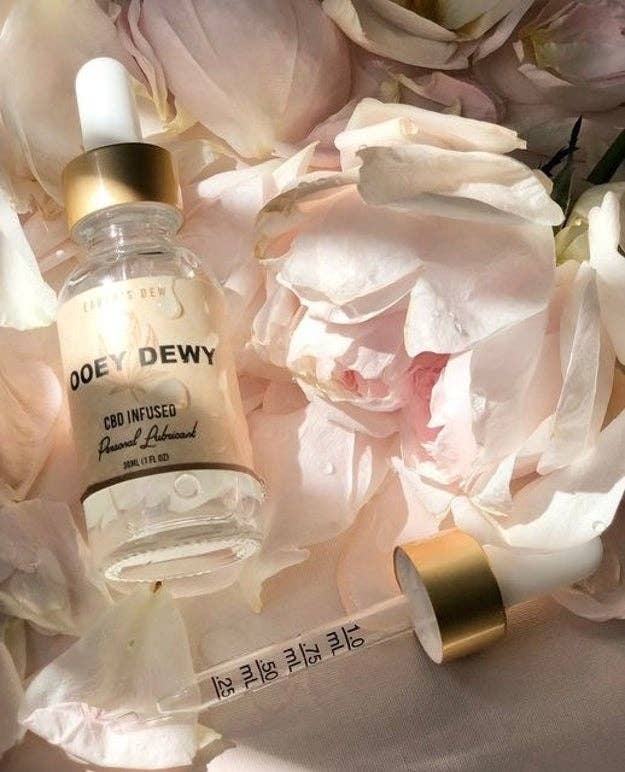 Bottle of serum with dropper on bed of roses