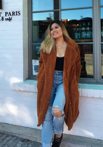 another reviewer wearing the brown coat