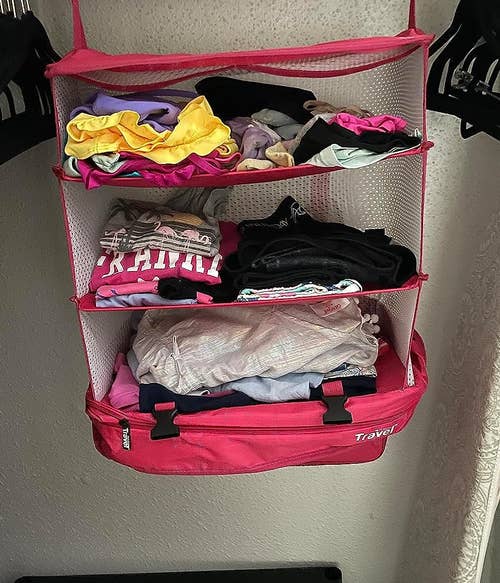 reviewer's pink packing cube hanging in closet