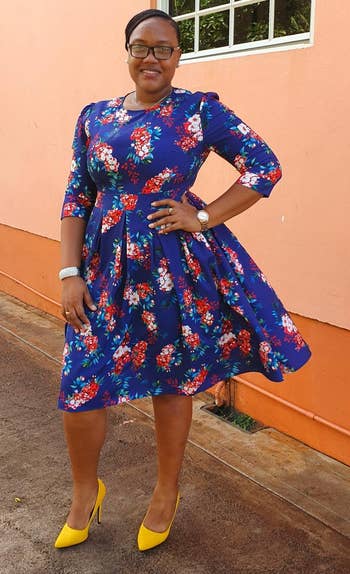 reviewer wearing the blue floral print dress