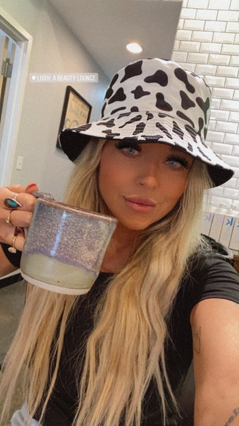 reviewer in cow print hat