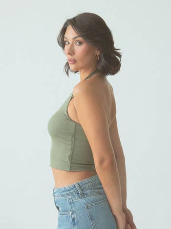 A model poses in a green halter-top