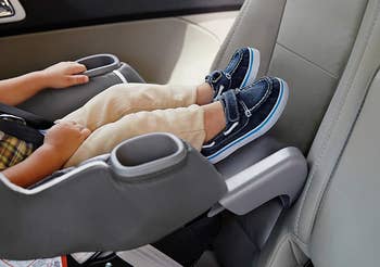 close-up image of child's feat using extendable leg room option in rear-facing car seat 