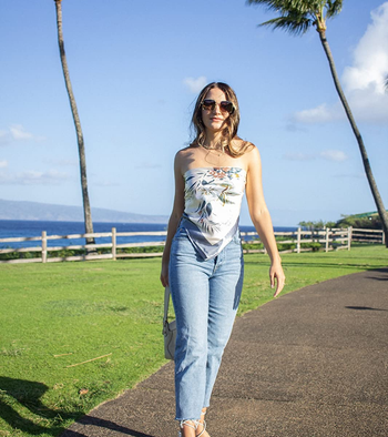 another reviewer wearing the medium wash version with a tube top