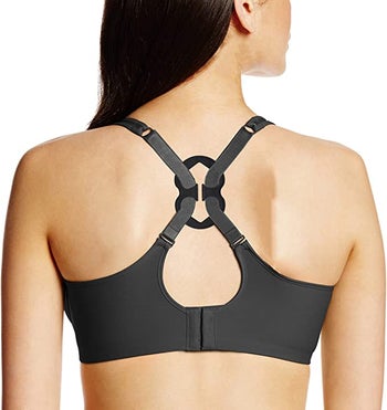 model using bra clip to pull straps together from the back