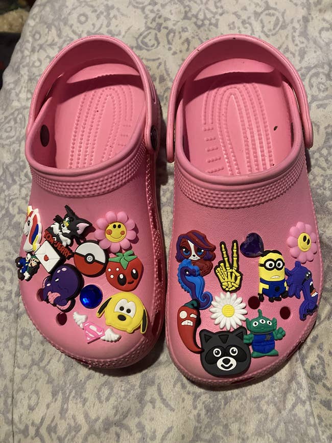 reviewer's crocs with tons of charms on them