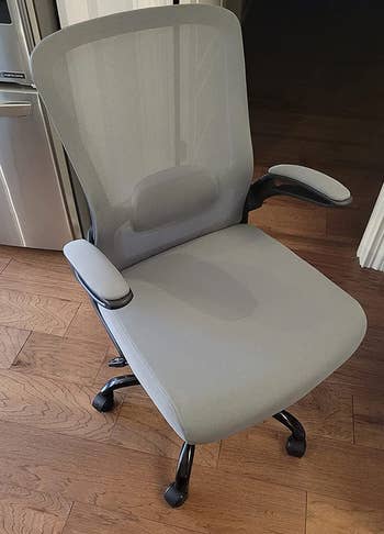 a reviewer photo of the chair in light gray 