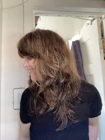 reviewer's shag style hair with choppy layers and bangs created with the same pair of shears