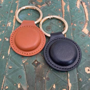 a brown and black magnetic purse hanger next to each other