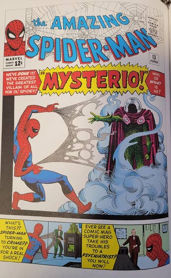 Reviewer's book open showing comic with Mysterio